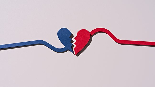 A broken heart with the left piece blue and the right piece red