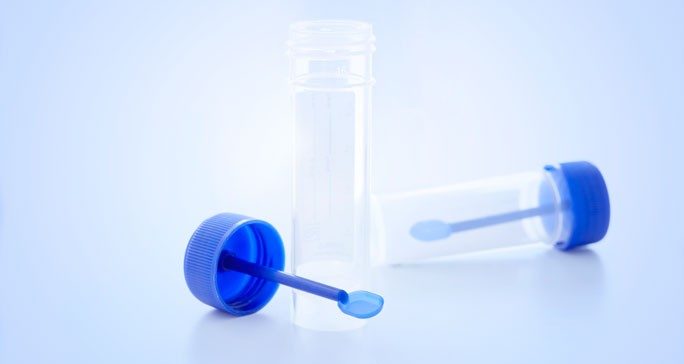 Two empty containers for stool collection on a light blue background