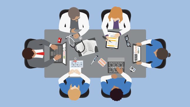 Bird's-eye view of six medical professionals sitting around a conference room table
