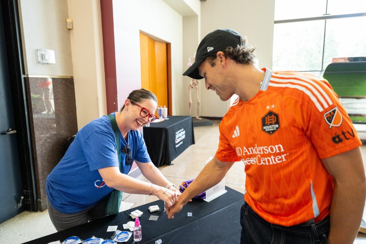 Houston Dynamo FC defender Erik Sviatchenko get a temporary cancer strikethrough tattoo while supporting tobacco prevention at MD Anderson day at The Health Museum