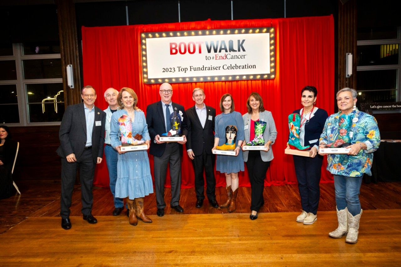 People holding commemorative boots