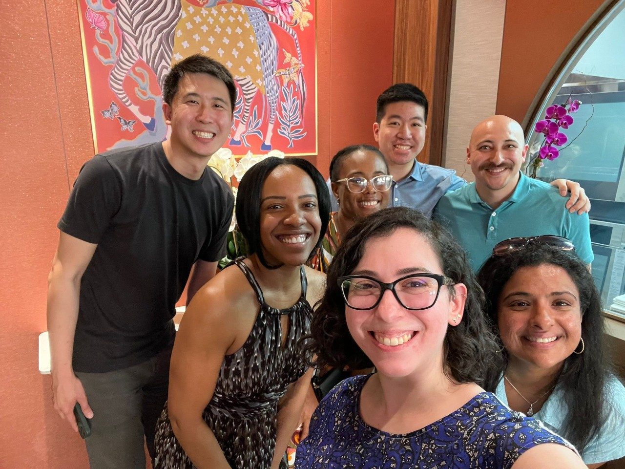fellows posing for selfie at restaurant