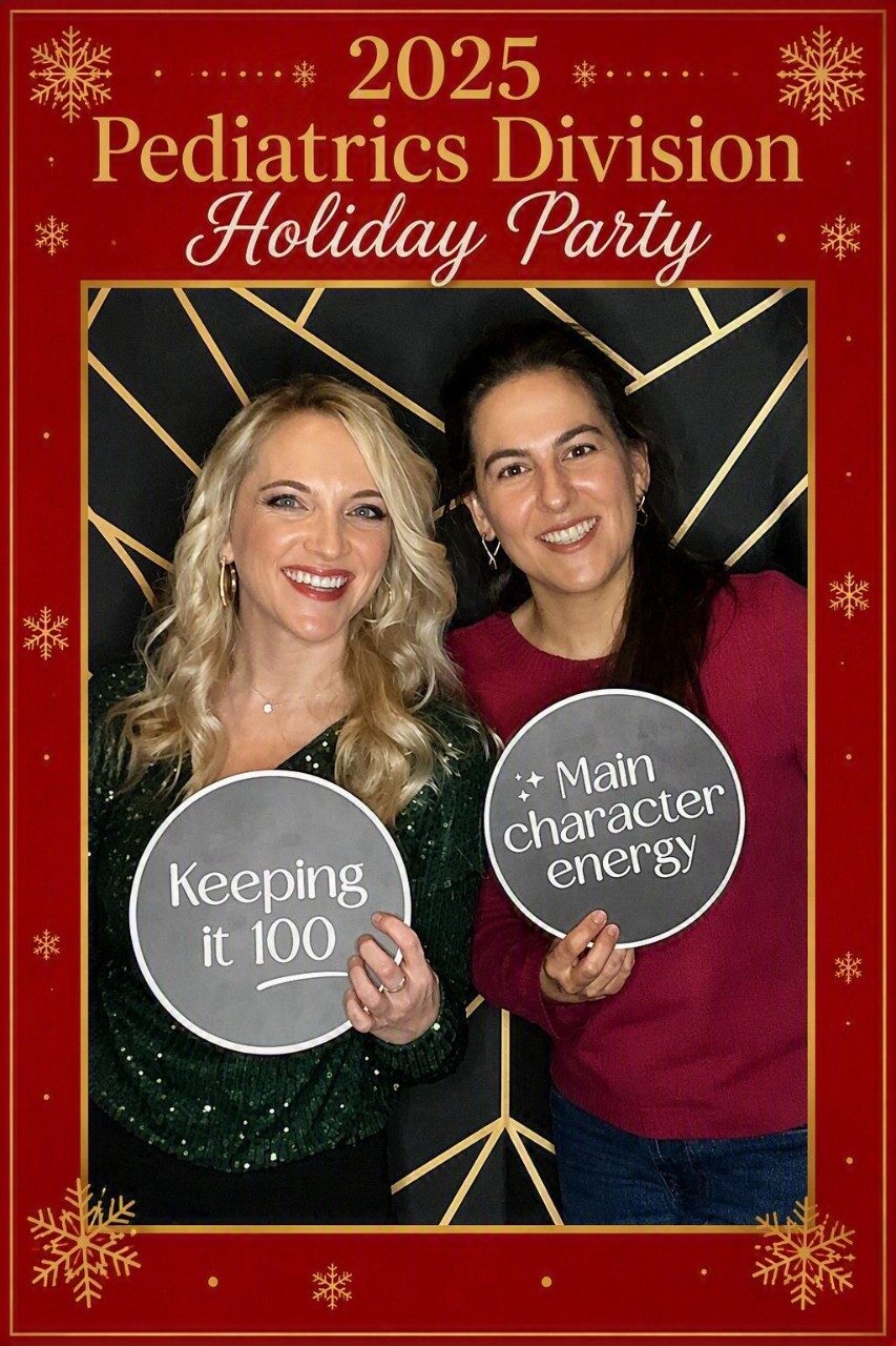 Two fellows taking a picture at a holiday party