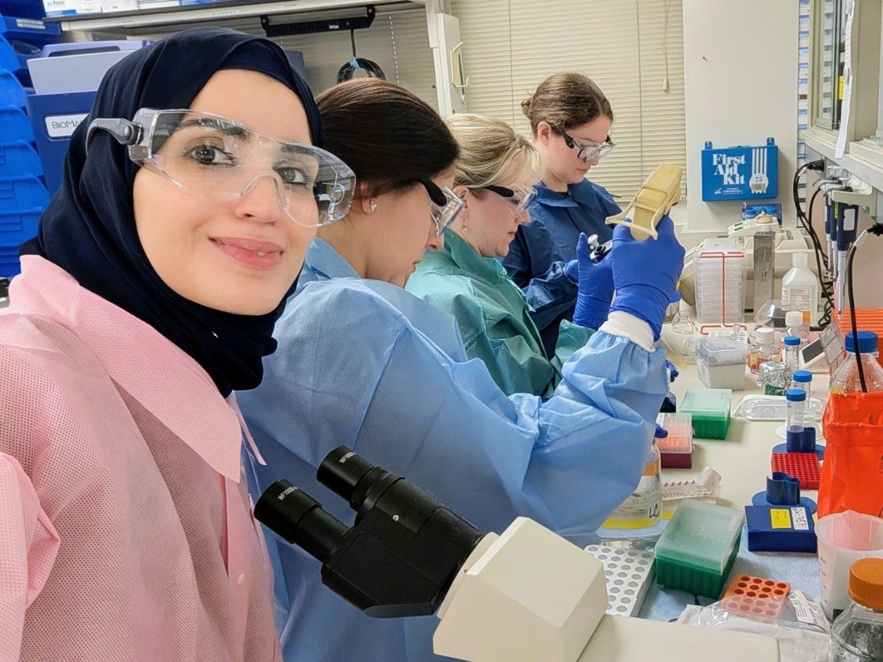 Fellows using tools in a lab