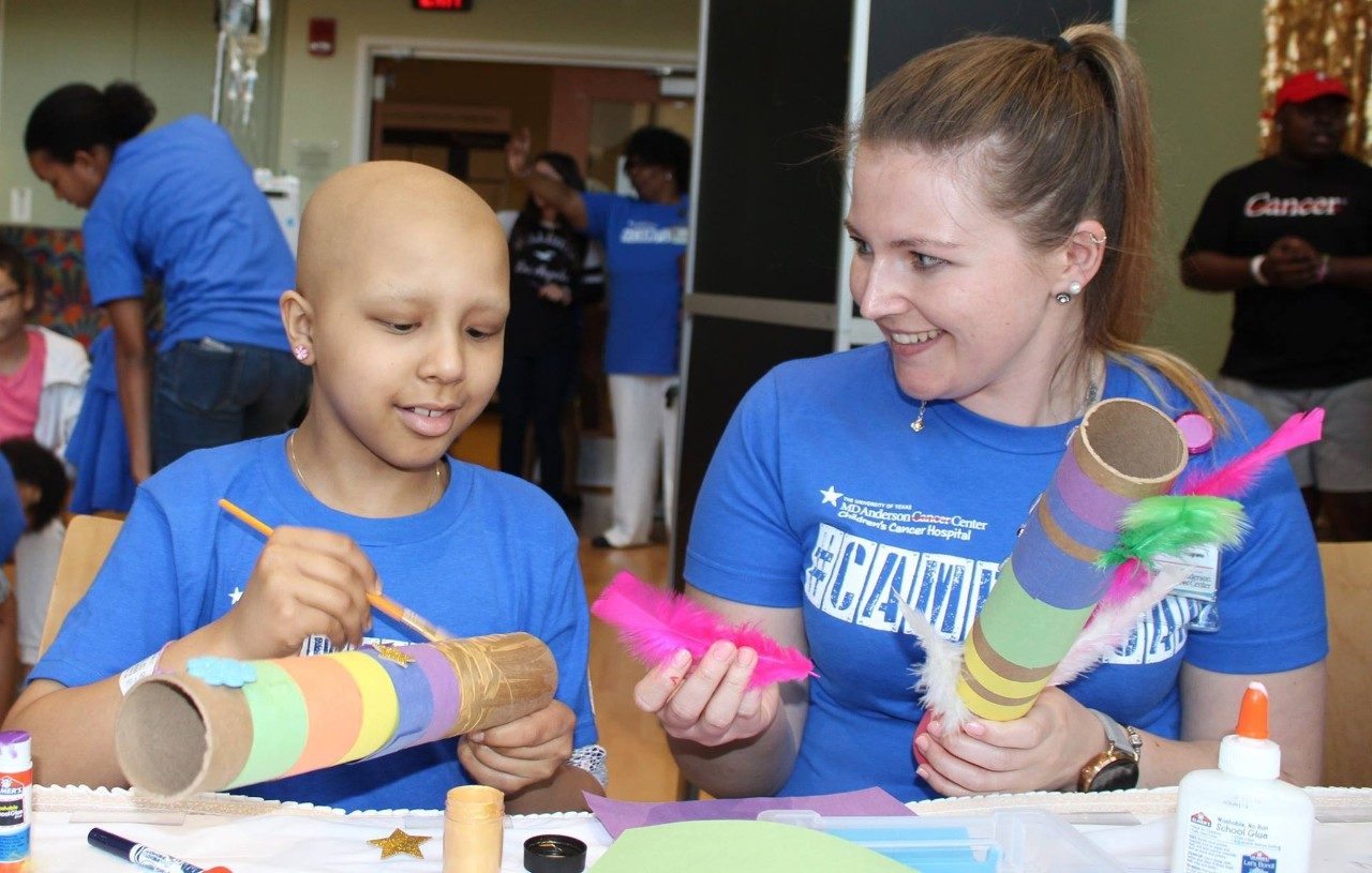 Pediatric patient receives art instruction from staffer