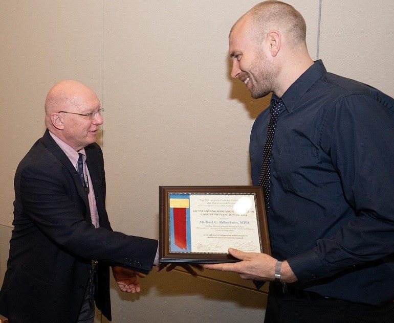 CPRTP Summer alum (2015), Michael Robertson, PhD, receives the 2019 Outstanding Research Trainee Award from Dr. Ernest Hawk, VP of Cancer Prevention.