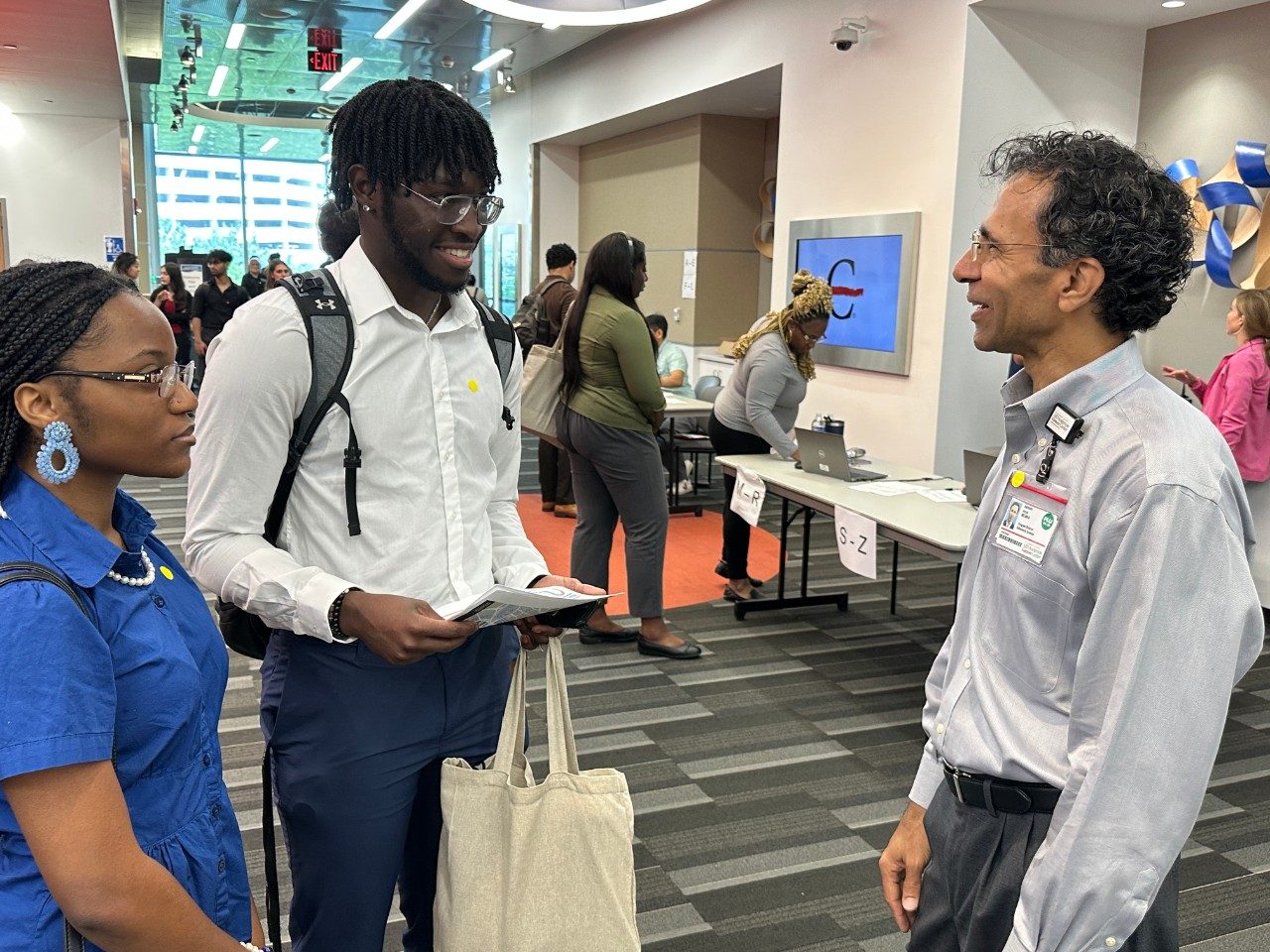 three people engaging in conversation