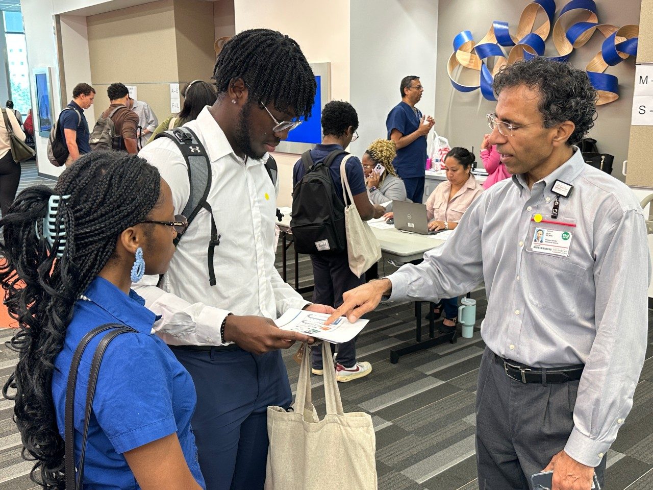 Three people facing each other in conversation 