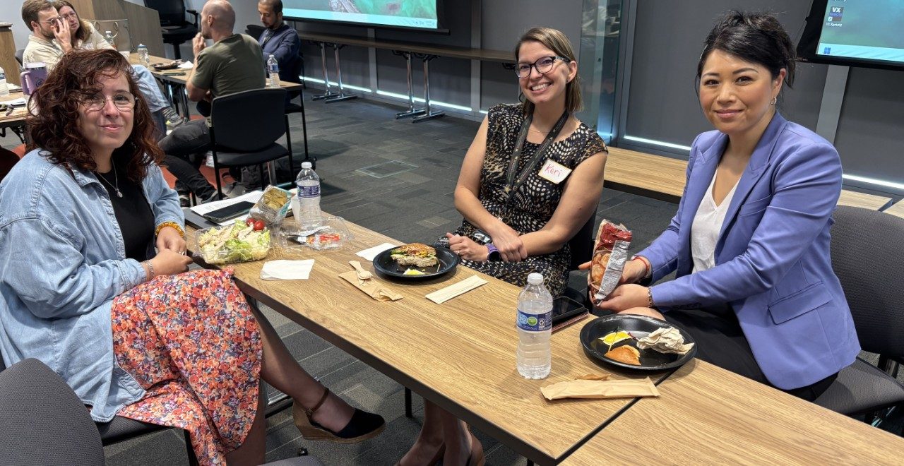 three people pose for a photo