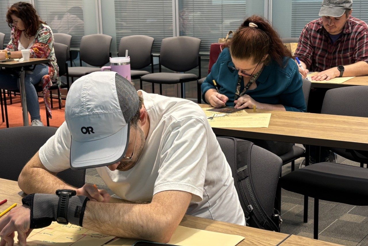 three people drawing