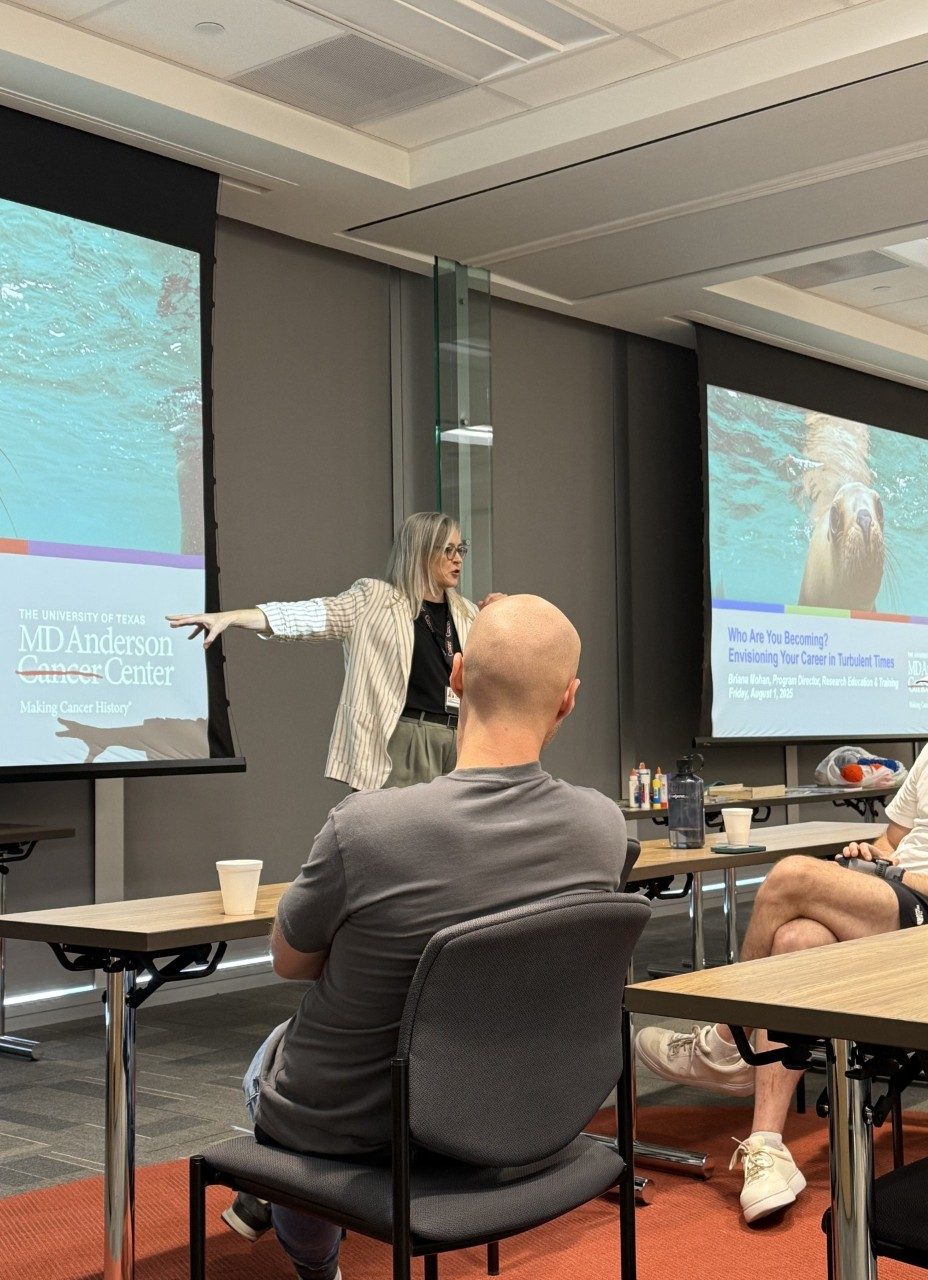 a person presenting with a presentation visible in the background