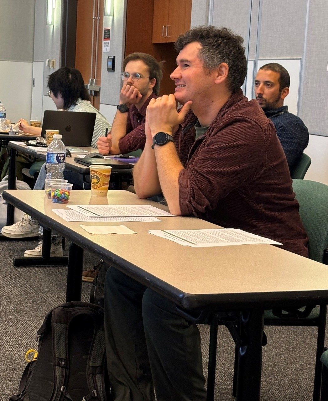current odyssey fellows listening to a presentation while seated at tables