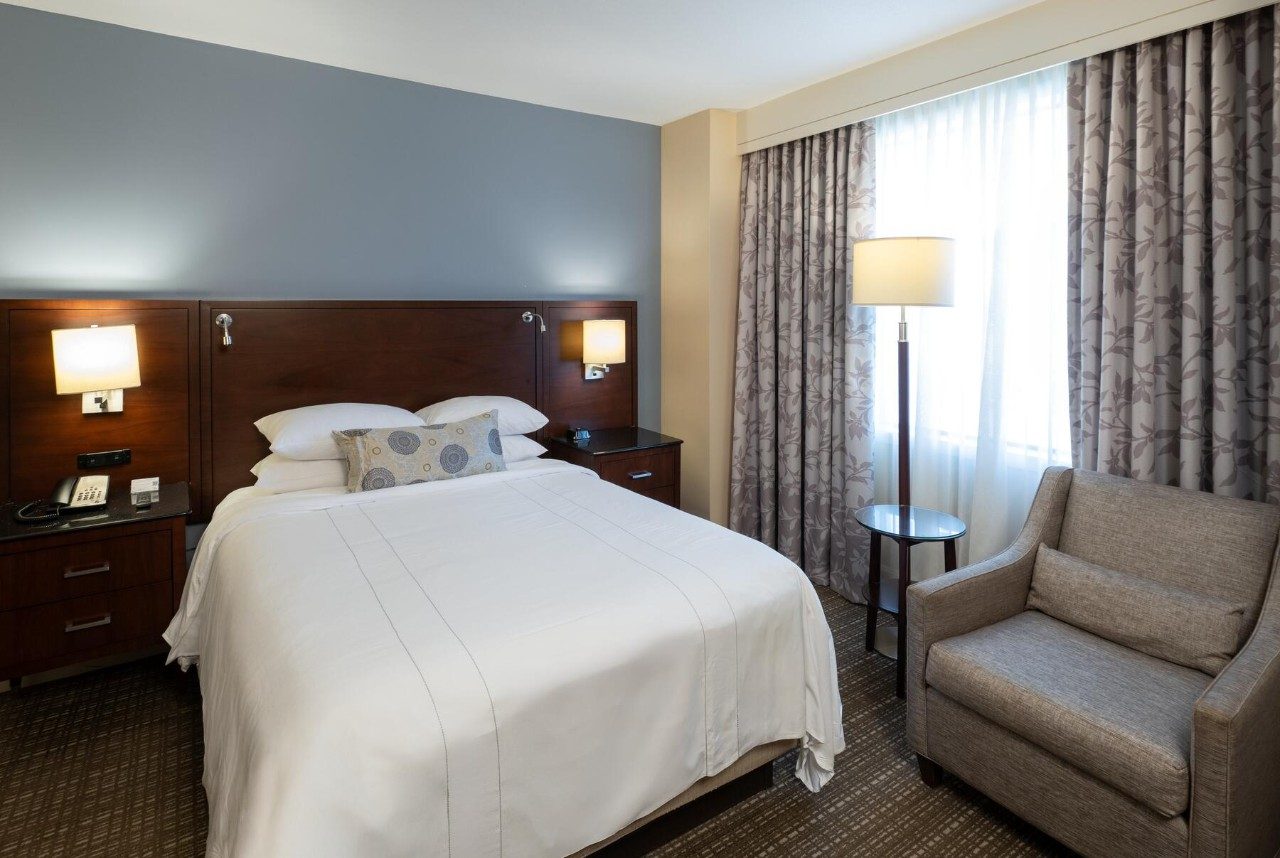 Bedroom in a suite with one queen bed and kitchenette