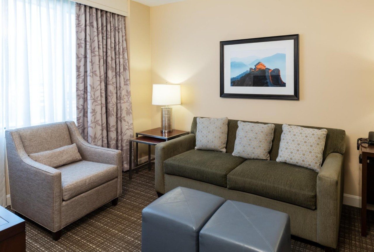 Living area in a suite with one queen bed and kitchenette