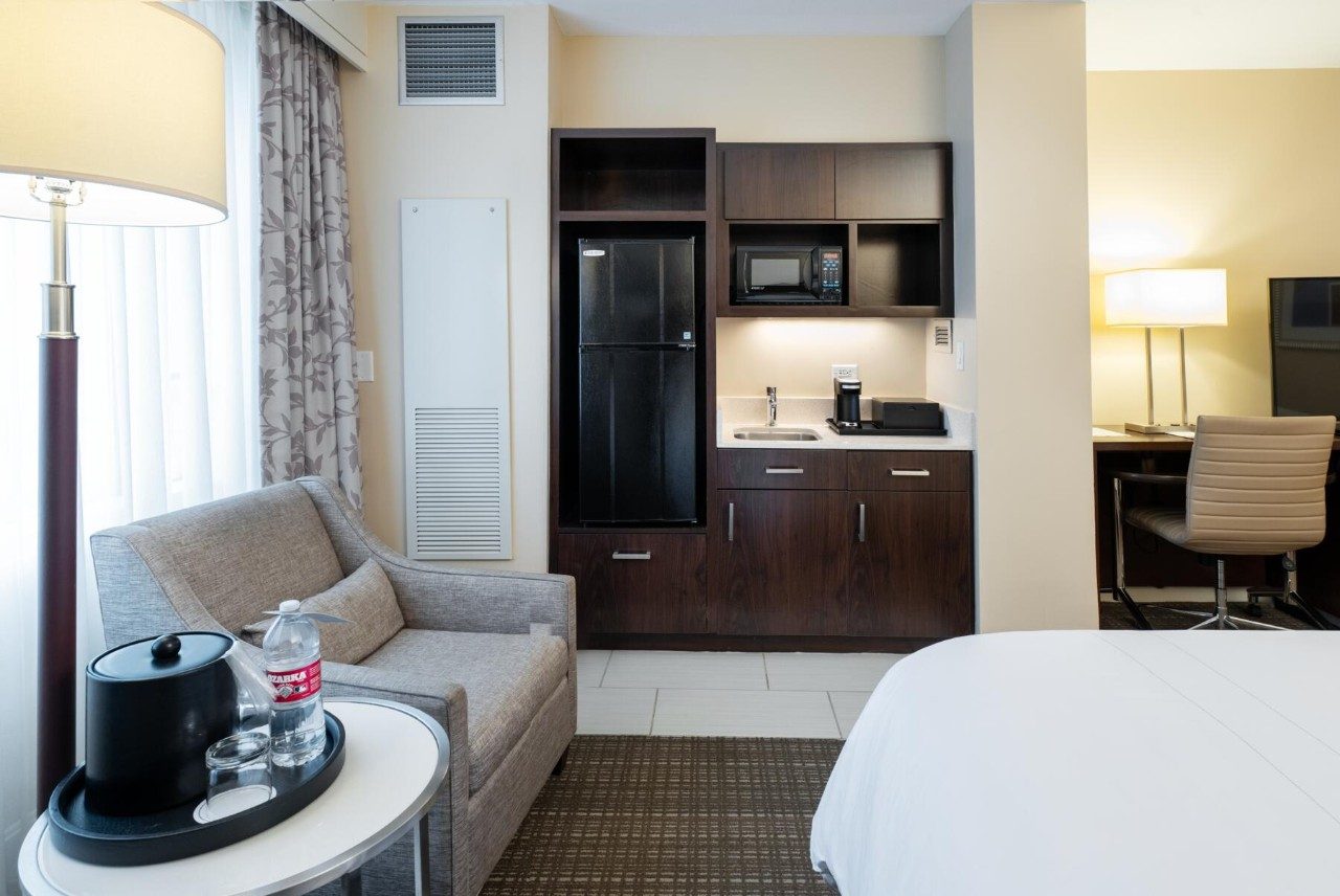 Living area and kitchenette in a room with two queen beds and kitchenette