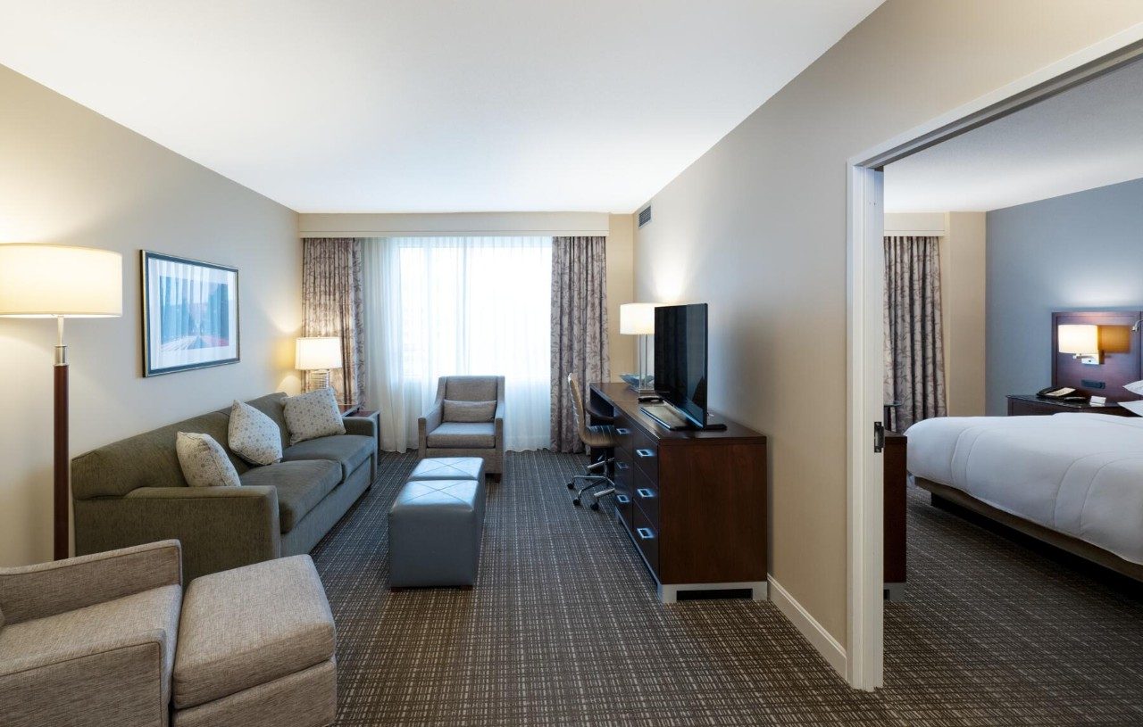 Living area in a suite with king bed and kitchenette