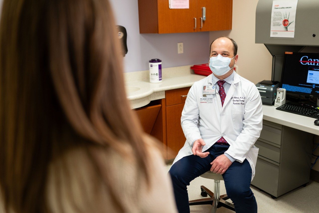 Dr. Tyler Hillman speaking with a patient in the Gynecologic Oncology clinic