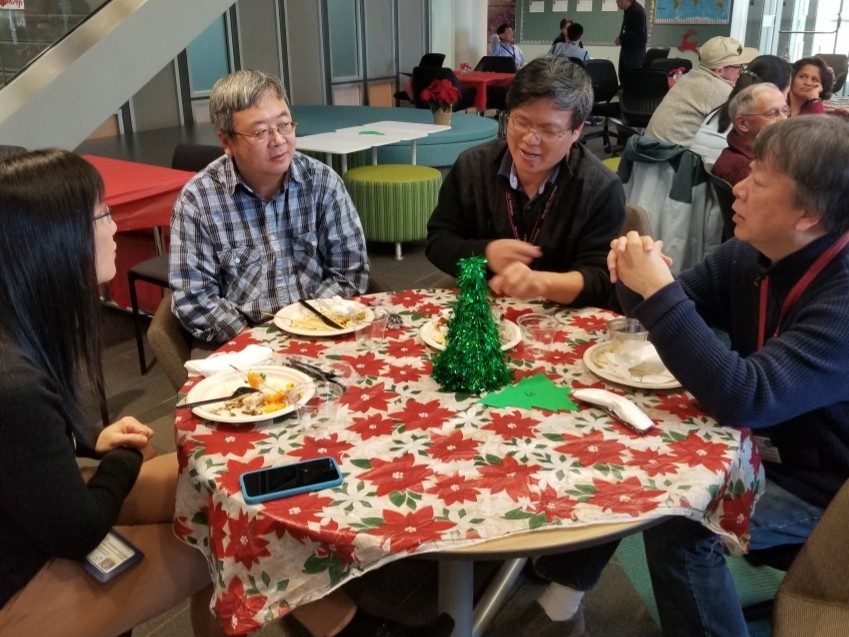 Four poeple sit around a table