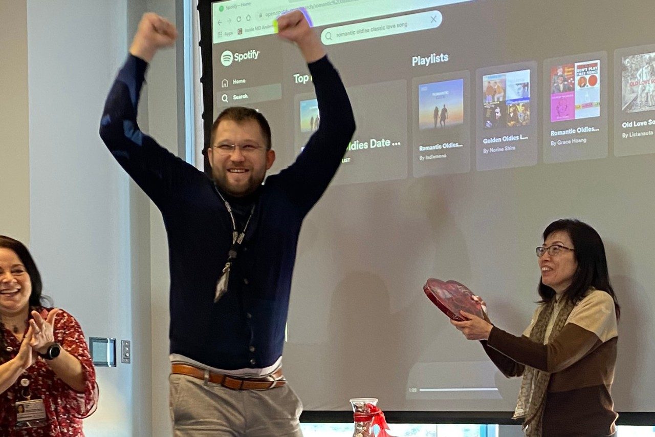  Two people in front of a screen