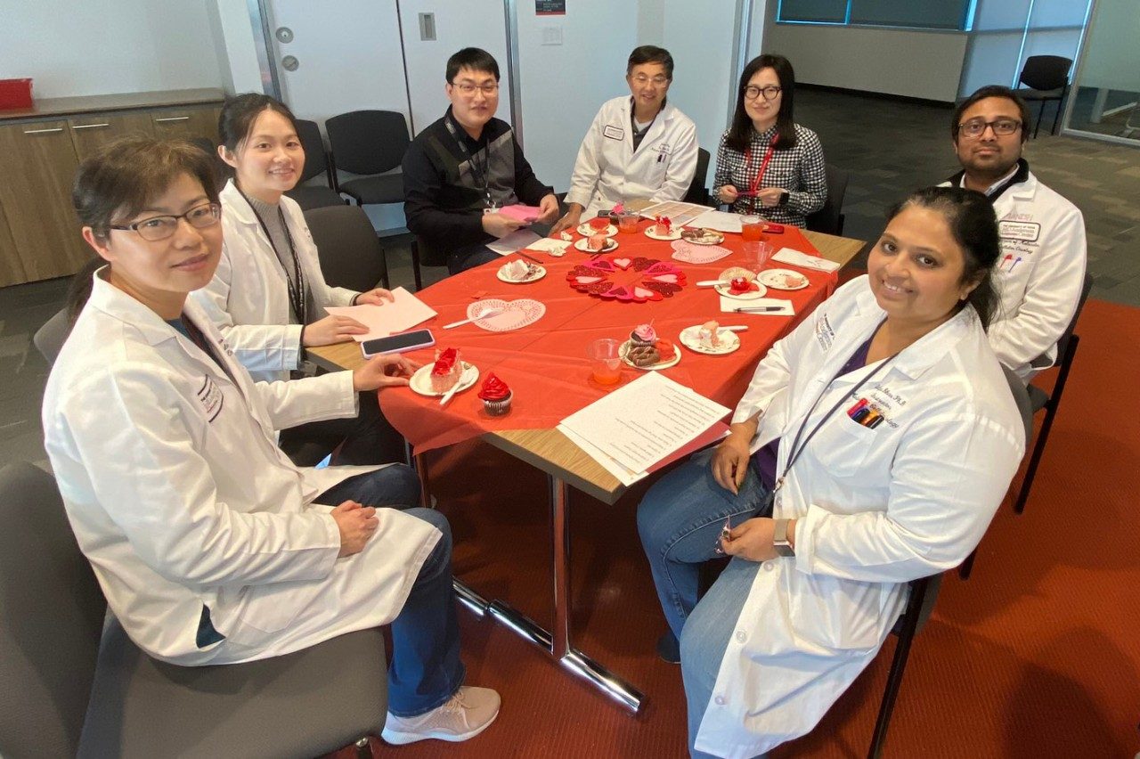 Seven people sit at a table