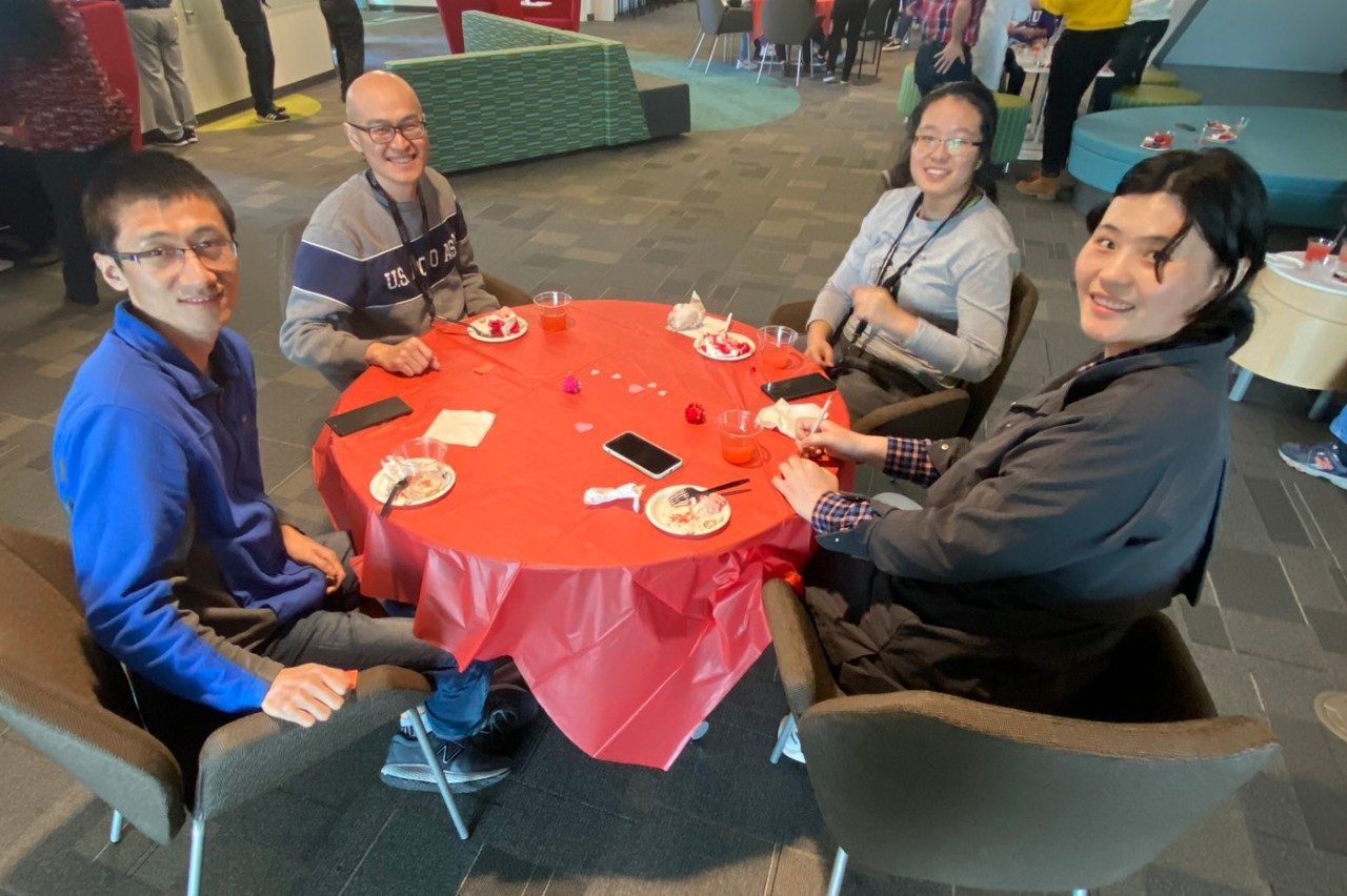 Four people sit around a table