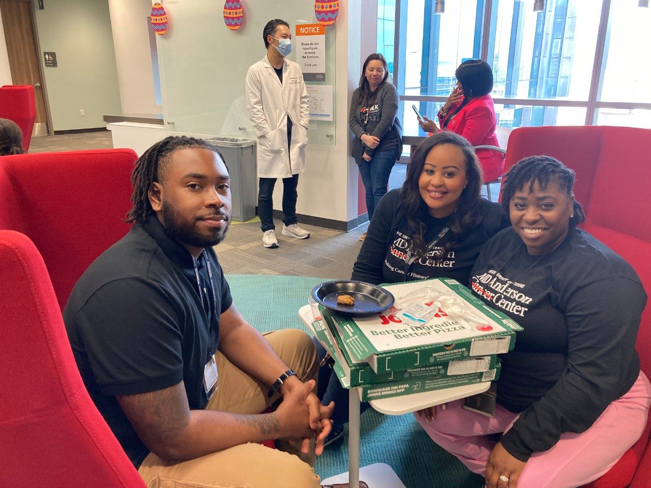 Six people with pizza boxes