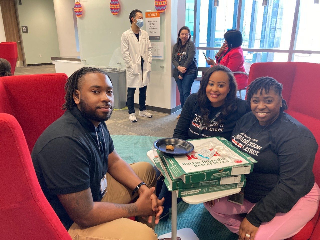 Six people with pizza boxes