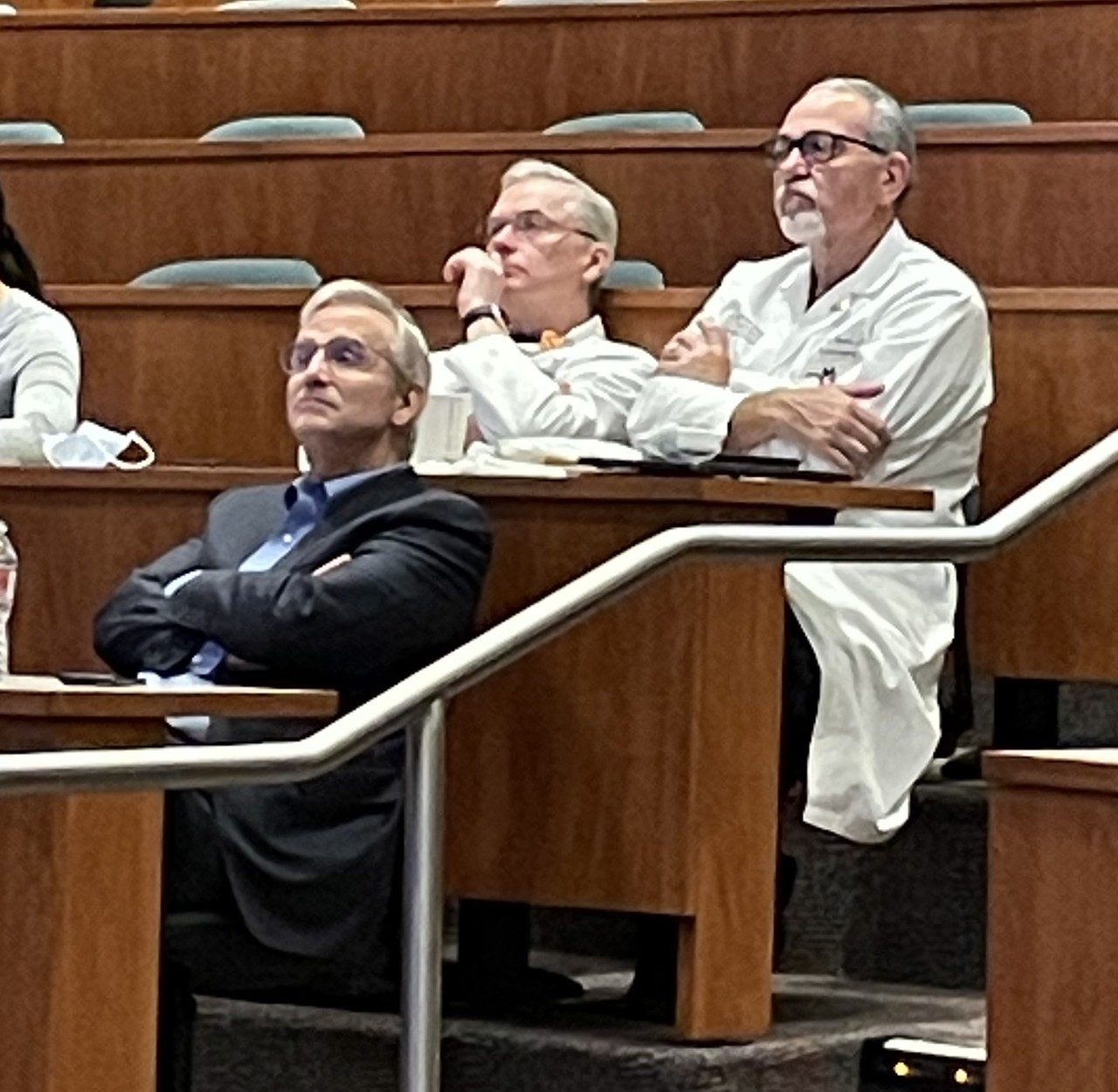 Frederick Lang, MD, Paul Gidley, MD and Franco DeMonte, MD seated in a lecture hall.