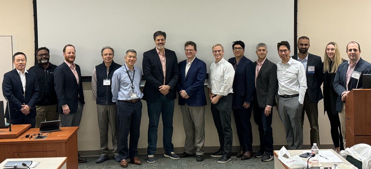 A group of 14 doctors poses for a group photo