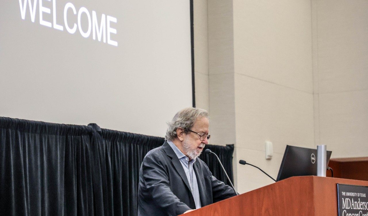 Dr. Allison speaking at a podium