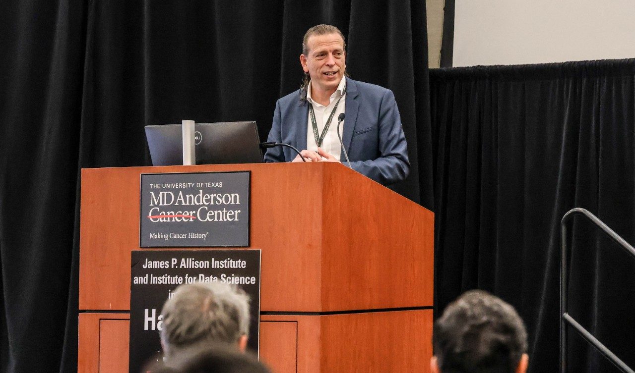 Dr. Jaffray speaking at a podium