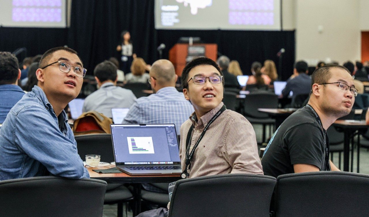 Three men look behind them