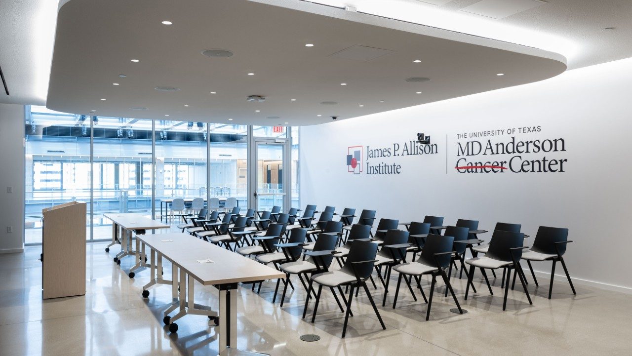 An empty classroom with the Allison Institute logo
