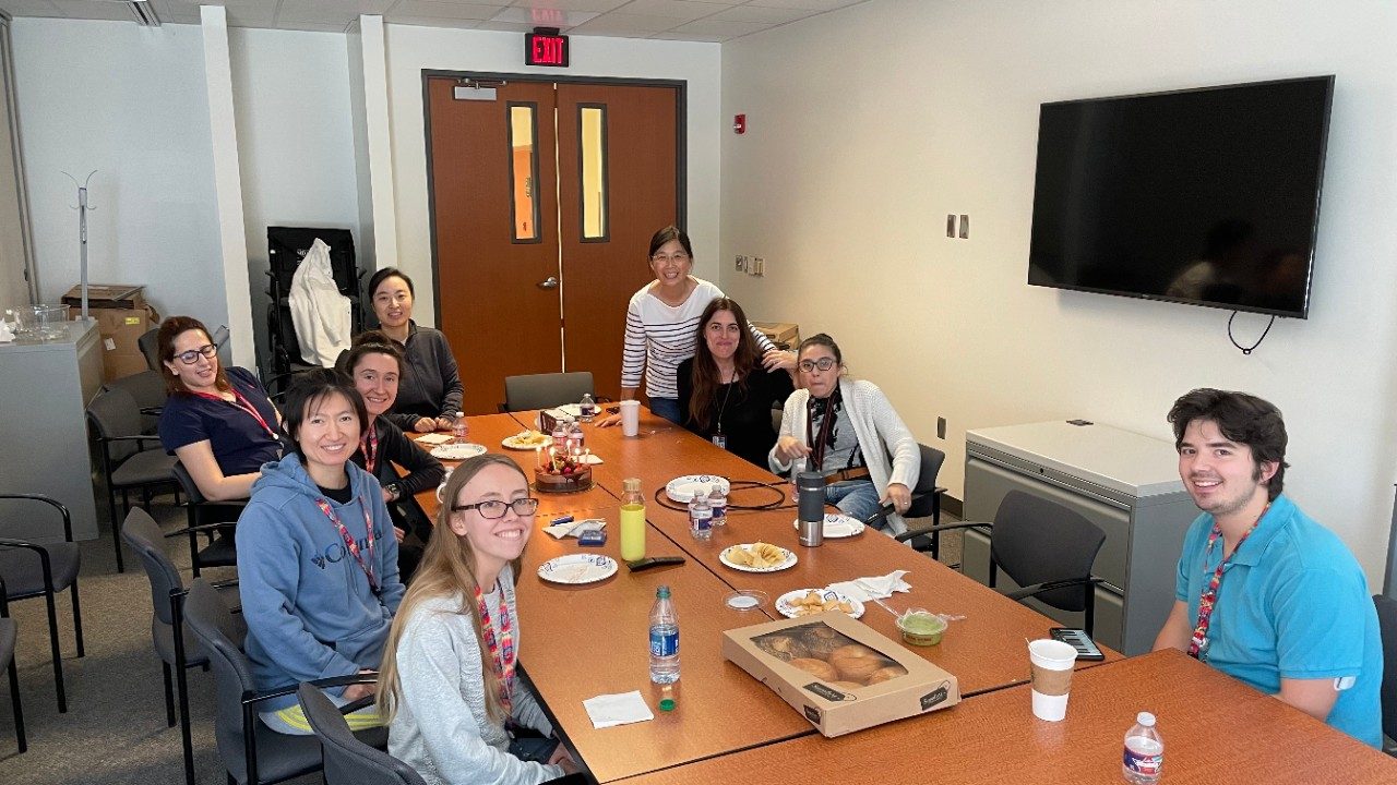 A group of people gathered around tables in a conference room