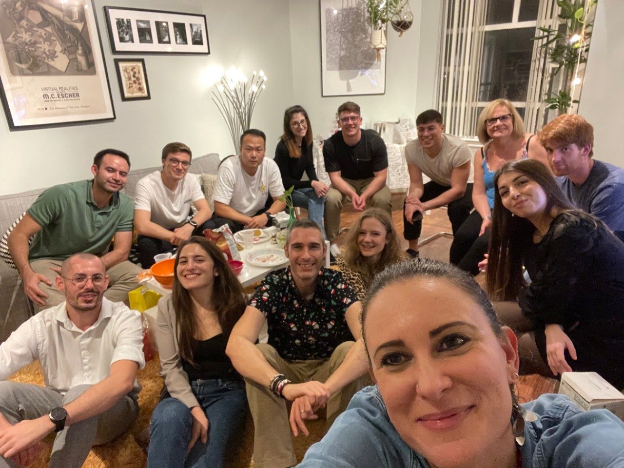 Group photo of lab members in a living room, dressed casually