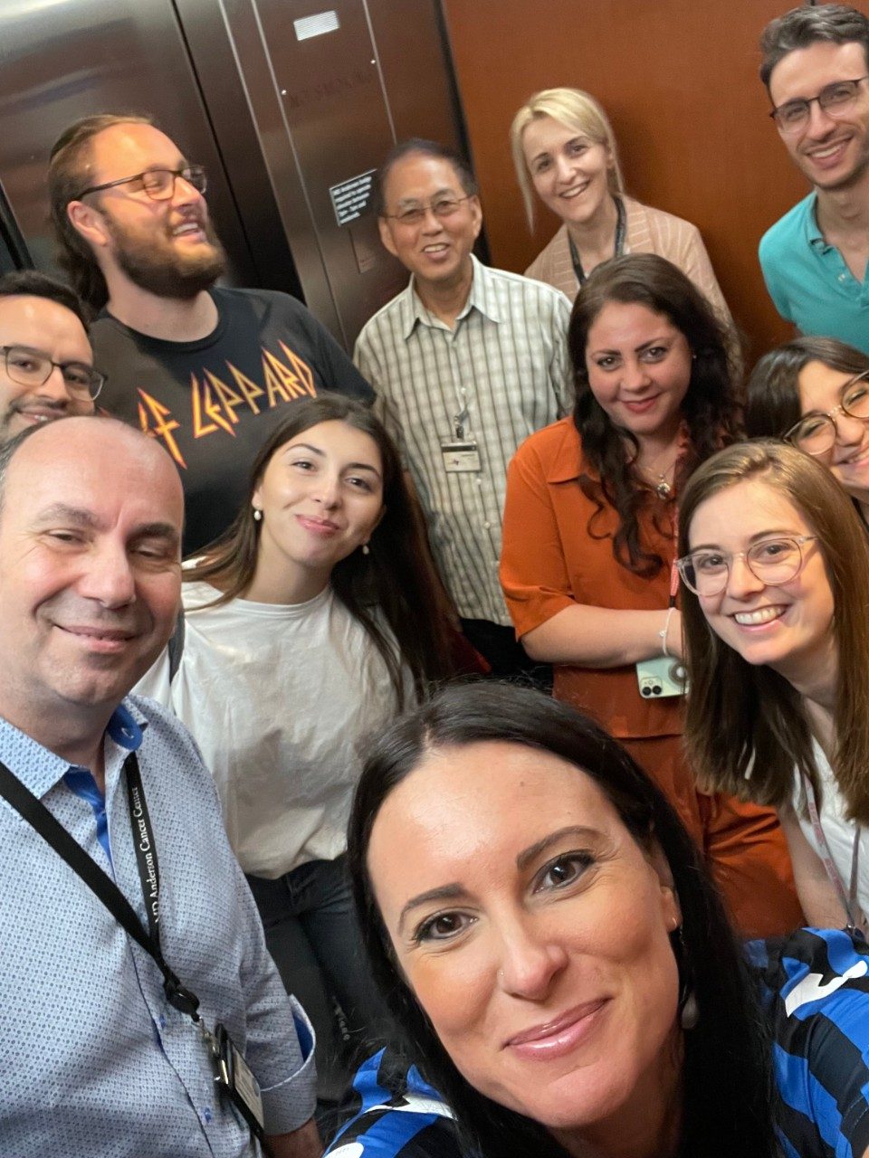 Group selfie taken in an elevator