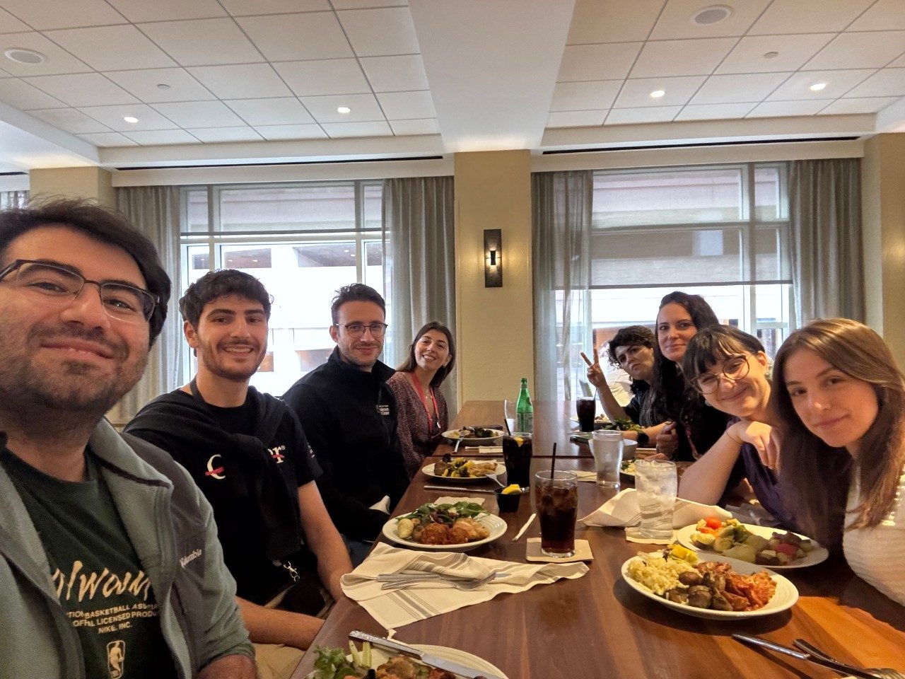 Group picture of 8 people seated at a restaurant table