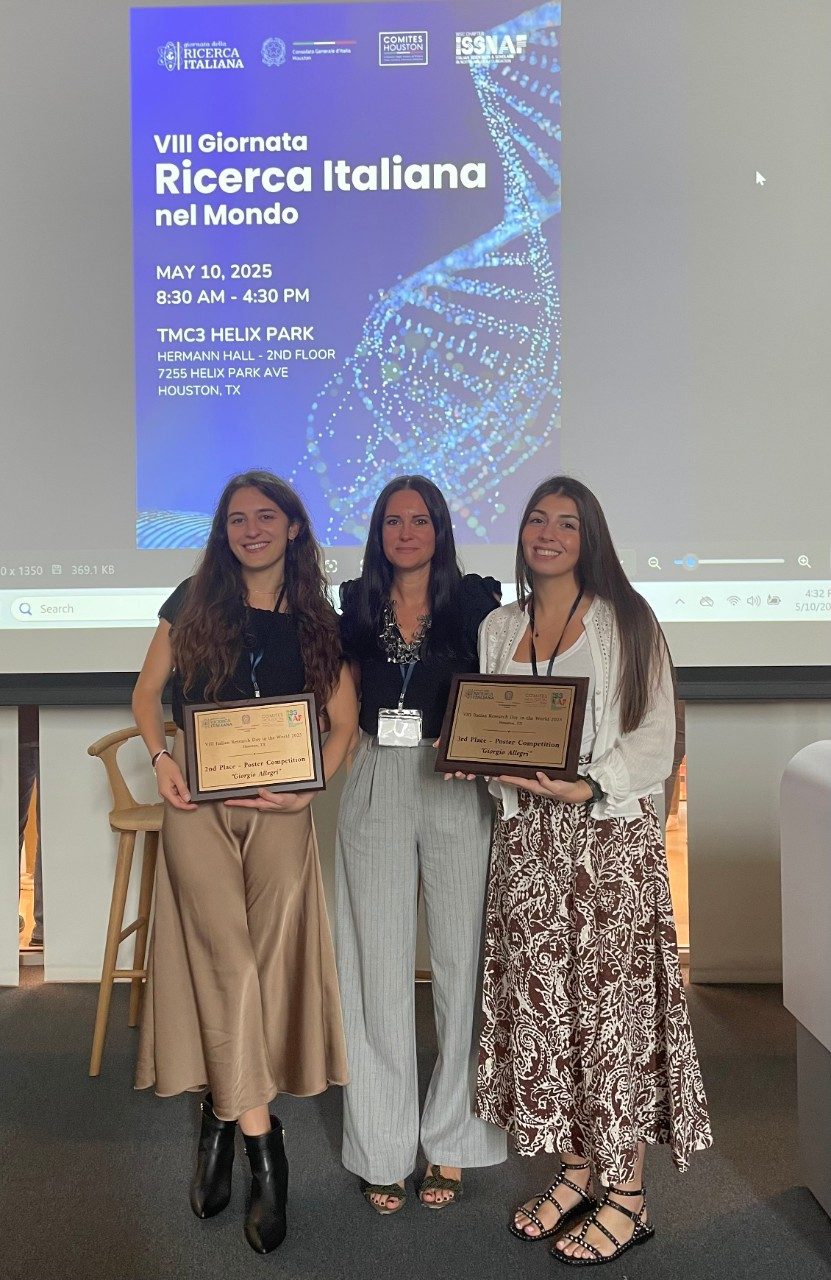 Three women holding plaques posed together