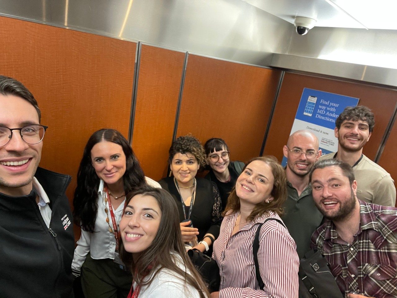 Group selfie taken in an elevator