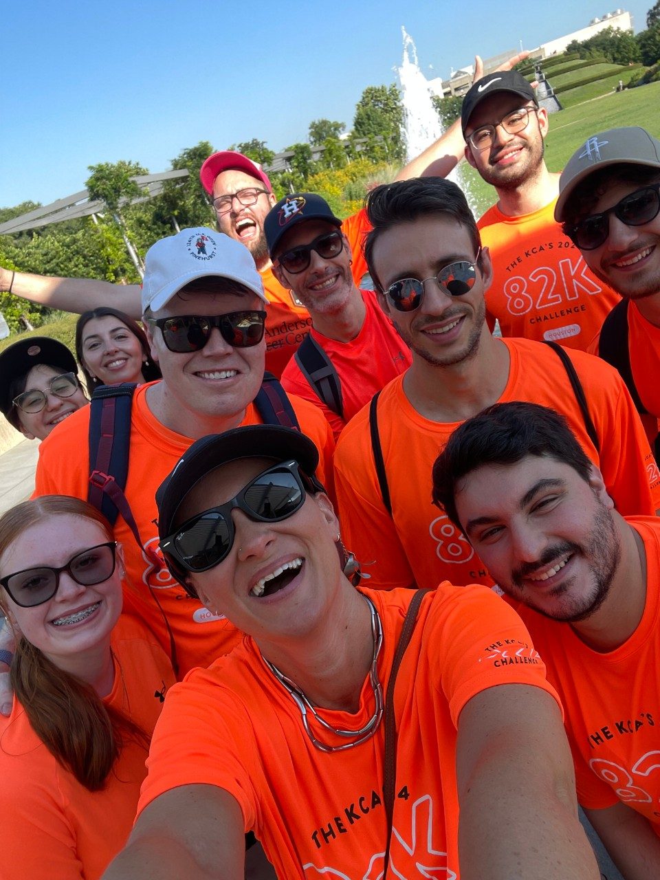 Selfie of group of people in neon orange shirts