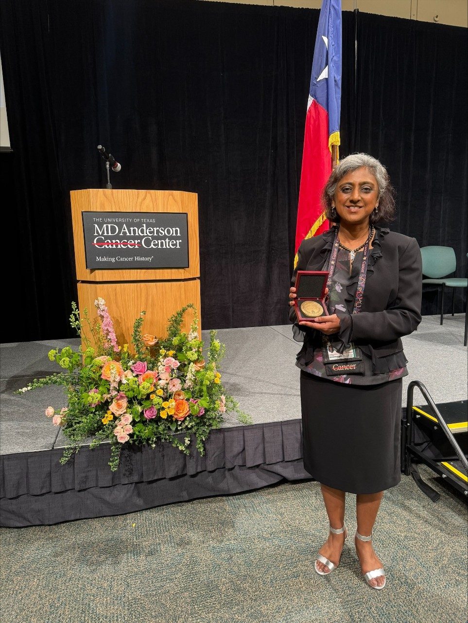 Dr. Chandra posing with award