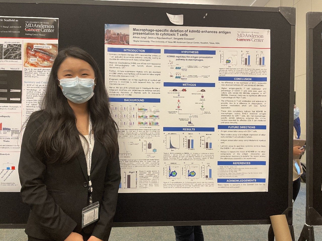 Woman in mask stands in front of a poster