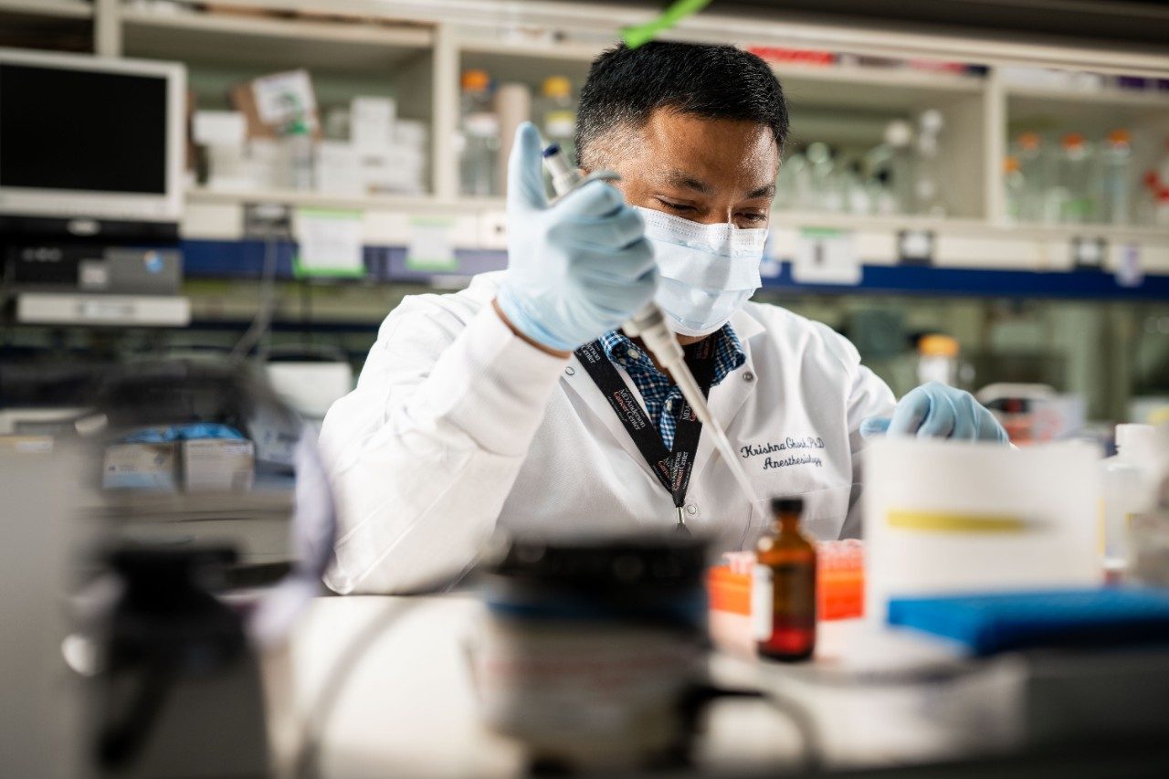 Krishna Ghosh, Ph.D., works in the lab