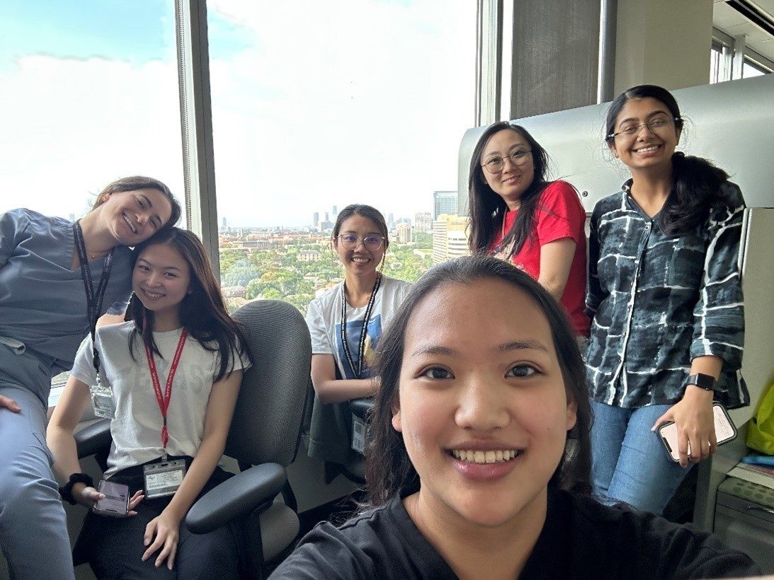 Selfie of 6 lab members in front of a window
