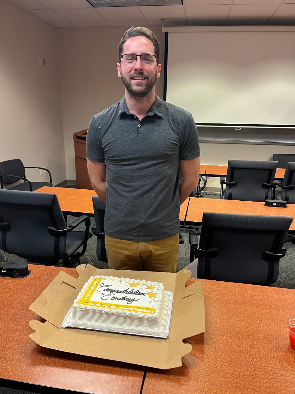 Man posing with a cake