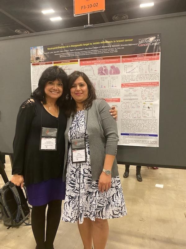 Two people in front of a scientific poster 