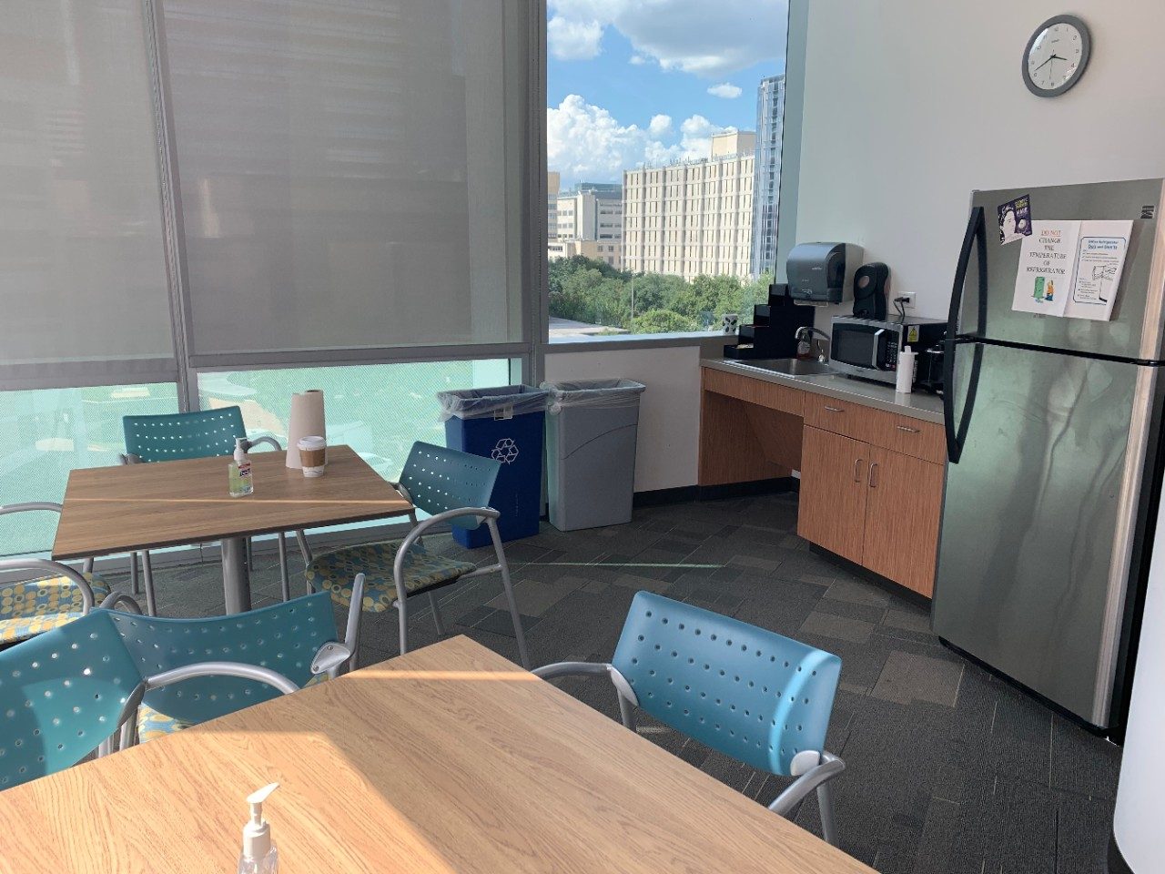 Room with tables and chairs and a kitchen