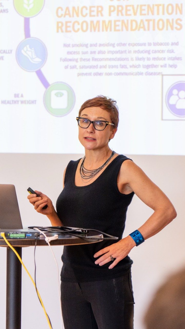 A woman stands behind a lectern