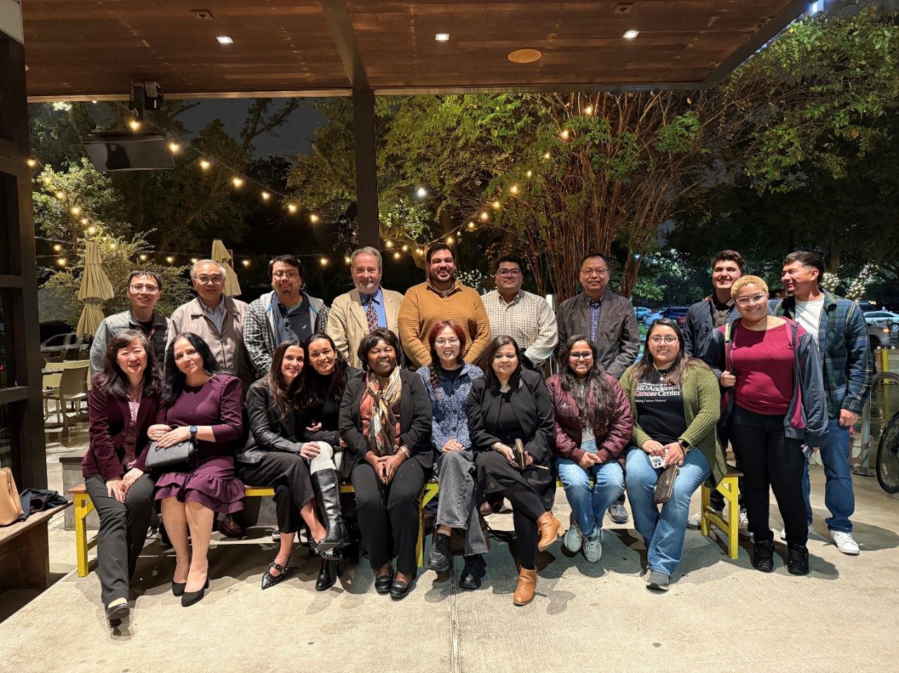 Large group of people posing outside a restaurant