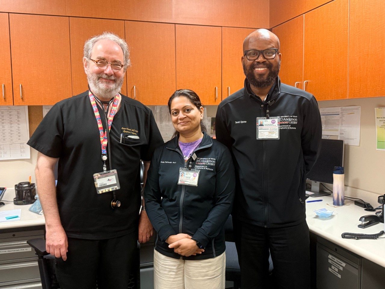 Dr. Orlowski posing with two lab members